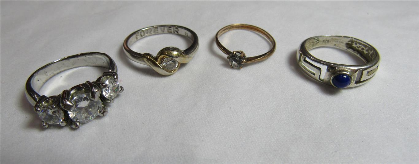 Four stone set dress rings in rolled gold, 925 silver or white metal. Ring sizes K 1/2, N, P 1/2 and