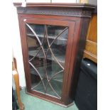 A mahogany four tier glass fronted corner cabinet