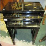 A nest of three black lacquered occasional tables of oriental design