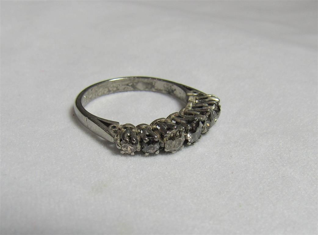 A vintage platinum and graduated seven stone diamond dress ring, marked Plat and inscripted 22/12/51