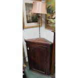 An early 19th century oak corner cabinet with two shelves together with an Art Deco type metal