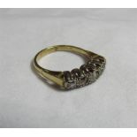 A marked 18ct gold and platinum five stone graduated diamond dress ring with the largest central