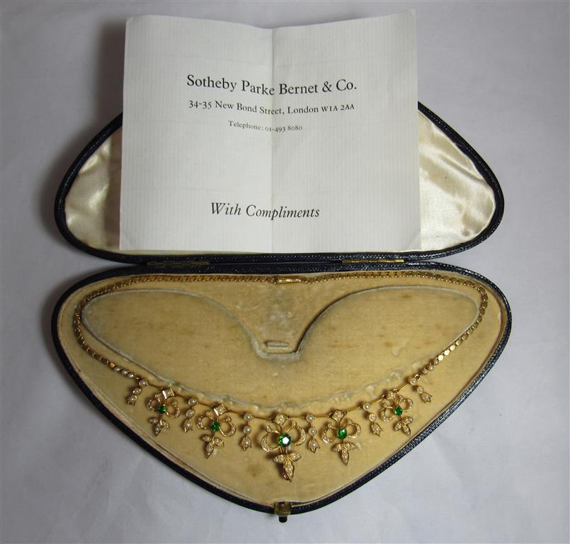 An unmarked gold (tested) seed pearl and green stone collar necklace measuring 38.5cm in length.