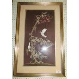 A framed silk tapestry on silk of oriental design with two white doves on a tree
