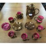A Welsh bronze and crimson lustre coffee set
