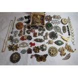 A collection of vintage costume jewellery comprising mostly brooches and badges to include an ARP