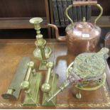 A copper and brass kettle, brass bellows, brass trivet, a pair of brass dogs, two brass candlesticks