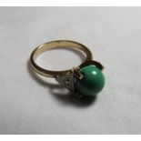 An interesting unmarked gold (tested)ring set with a moving spherical turquoise bead (