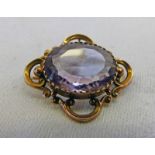 OVAL AMETHYST SET BROOCH MARKED 9CT IN DECORATIVE SETTING