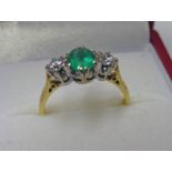 18CT GOLD EMERALD & DIAMOND SET 3 STONE RING.