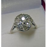 OLD CUT DIAMOND SET CLUSTER RING IN SETTING MARKED PLATINUM. THE DIAMOND OF APPROX. 1.