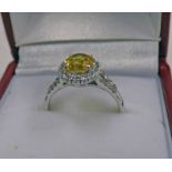 A YELLOW SAPPHIRE AND DIAMOND CLUSTER RING,