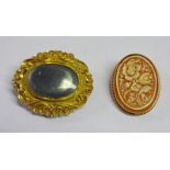 OVAL CAMEO BROOCH WITH FLORAL DECORATION IN 9 CARAT GOLD MOUNT AND OVAL VICTORIAN MOURNING BROOCH