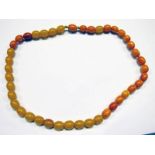 STRING OF AMBER COLOURED BEADS 38 GMS