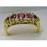 18CT GOLD 5 STONE RUBY SET RING WITH DIAMOND POINTS Condition Report: Ring size: N.