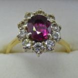 18CT GOLD RUBY AND DIAMOND CLUSTER RING,