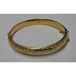 15CT GOLD BANGLE WITH ENGRAVED FRONT 12 GRAMS Condition Report: Marks clear: Chester