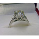 PLATINUM SET SOLITAIRE DIAMOND RING WITH STEPPED BAGUETTE CUT SHOULDERS. THE CENTRE STONE OF APPROX.