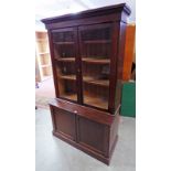 EARLY 20TH CENTURY PINE CABINET WITH 2 GLAZED DOORS OVER 2 PANEL DOORS ON PLINTH BASE.