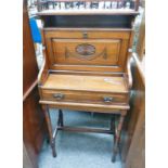 19TH CENTURY WALNUT WRITING DESK WITH GALLERY TOP AND CARVED DECORATION