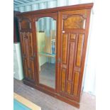 LATE 19TH CENTURY MAHOGANY & WALNUT TRIPLE MIRROR DOOR WARDROBE WITH CARVED DECORATION