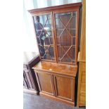 20TH CENTURY MAHOGANY BOOKCASE WITH 2 ASTRAGAL GLAZED DOORS OVER 2 PANEL DOORS OPEN PLINTH BASE