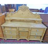 19TH CENTURY PINE KITCHEN DRESSER WITH GALLERIED BACK OVER 7 DRAWERS & PANEL DOOR ON TURNED