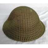 WW2 BRODIE HELMET WITH CAMOUFLAGE NETTING, LEATHER LINER AND CHIN STRAP,