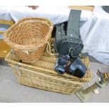 LARGE WICKER TRUNK WITH ROPE HANDLES, WICKER BASKET AND A MINOLTA XG - M CAMERA WITH VARIOUS LENSES.