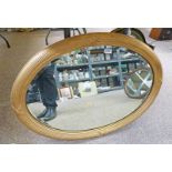 GILT FRAMED OVAL MIRROR WITH BEVELLED EDGE