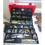 ONE BLACK AND RED PLASTIC TACKLE BOX WITH CONTENTS OF MANY DIFFERENT TYPES OF FISHING LURES AND