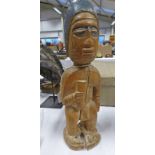 AFRICAN MALE STANDING FIGURE WITH SIMPLE COIFFURE HOLDING A VESSEL,