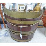 19TH CENTURY OVAL MAHOGANY BRASS BOUND BUCKET WITH SWING HANDLE.