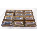 SELECTION OF TWELVE MAINLINE 00 GAUGE WAGONS INCLUDING 3 X 937362 - 3 PLANK WAGON ' E TURNER 7 SONS