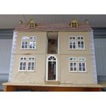 THREE STOREY DOLLS HOUSE WITH A SELECTION OF ACCESSORIES
