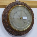 LATE 19TH / EARLY 20TH CENTURY CARVED OAK CIRCULAR BAROMETER WITH SILVERED DIAL BY NEGRETTI &