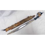 DAYAK HEAD HUNTERS SWORD WITH 49 CM LONG BLADE CARVED BONE HILT WITH CORD AND HAIR TASSELS IN A