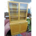 OAK BOOKCASE WITH 2 GLASS PANEL DOORS OPENING TO SHELVED AREA OVER 2 PANEL DOORS - WIDTH 106CM