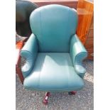 GREEN LEATHER AND MAHOGANY SWIVEL ARMCHAIR