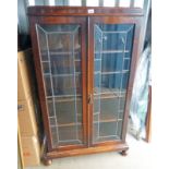 EARLY 20TH CENTURY OAK CABINET WITH 2 LEADED GLASS DOORS OVER SHELVED INTERIOR.