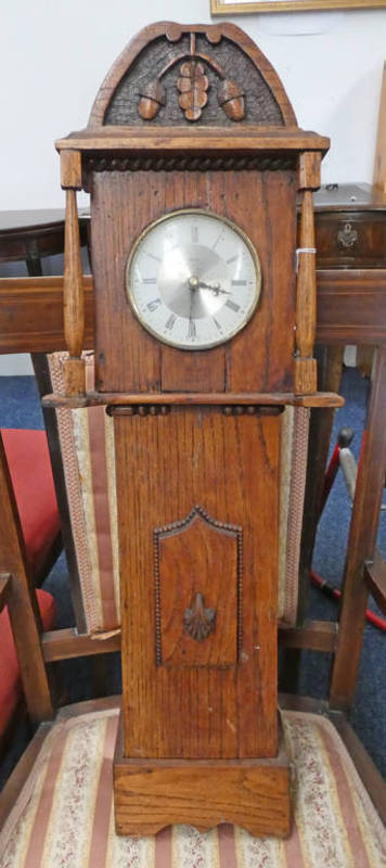 OAK CASED WALL CLOCK WITH CARVED DECORATION