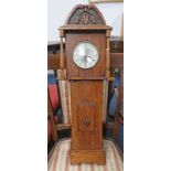 OAK CASED WALL CLOCK WITH CARVED DECORATION