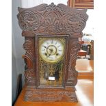 LATE 19TH CENTURY EARLY 20TH CENTURY AMERICAN MANTLE CLOCK WITH DECORATIVE CARVED CASE