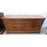 20TH CENTURY WALNUT LOW CHEST OF 2 SHORT AND 7 LONG DRAWERS ON BRACKET SUPPORTS,