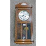 EARLY 20TH CENTURY OAK WALL CLOCK WITH GLASS PANEL DOOR