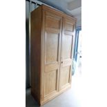 PINE KITCHEN CUPBOARD WITH 2 PANEL DOORS ON PLINTH BASE 218CM TALL