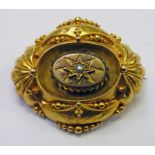 19TH CENTURY DECORATIVE GOLD LOZENGE SHAPED BROOCH WITH CENTRAL SEED PEARL WITHIN A STAR BURST