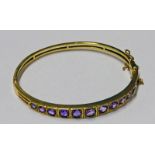 9CT GOLD AMETHYST BANGLE SET WITH 11 CIRCULAR GRADUATED AMETHYSTS