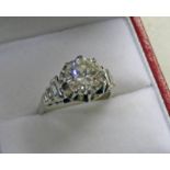 A DIAMOND SINGLE-STONE RING, THE BRILLIANT-CUT DIAMOND, BAGUETTE-CUT DIAMOND SHOULDERS,