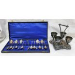 CASED SET OF 12 SILVER PLATED TEASPOONS AND TONGS WITH OWL DECORATION AND SILVER PLATED EGG CUPS ON